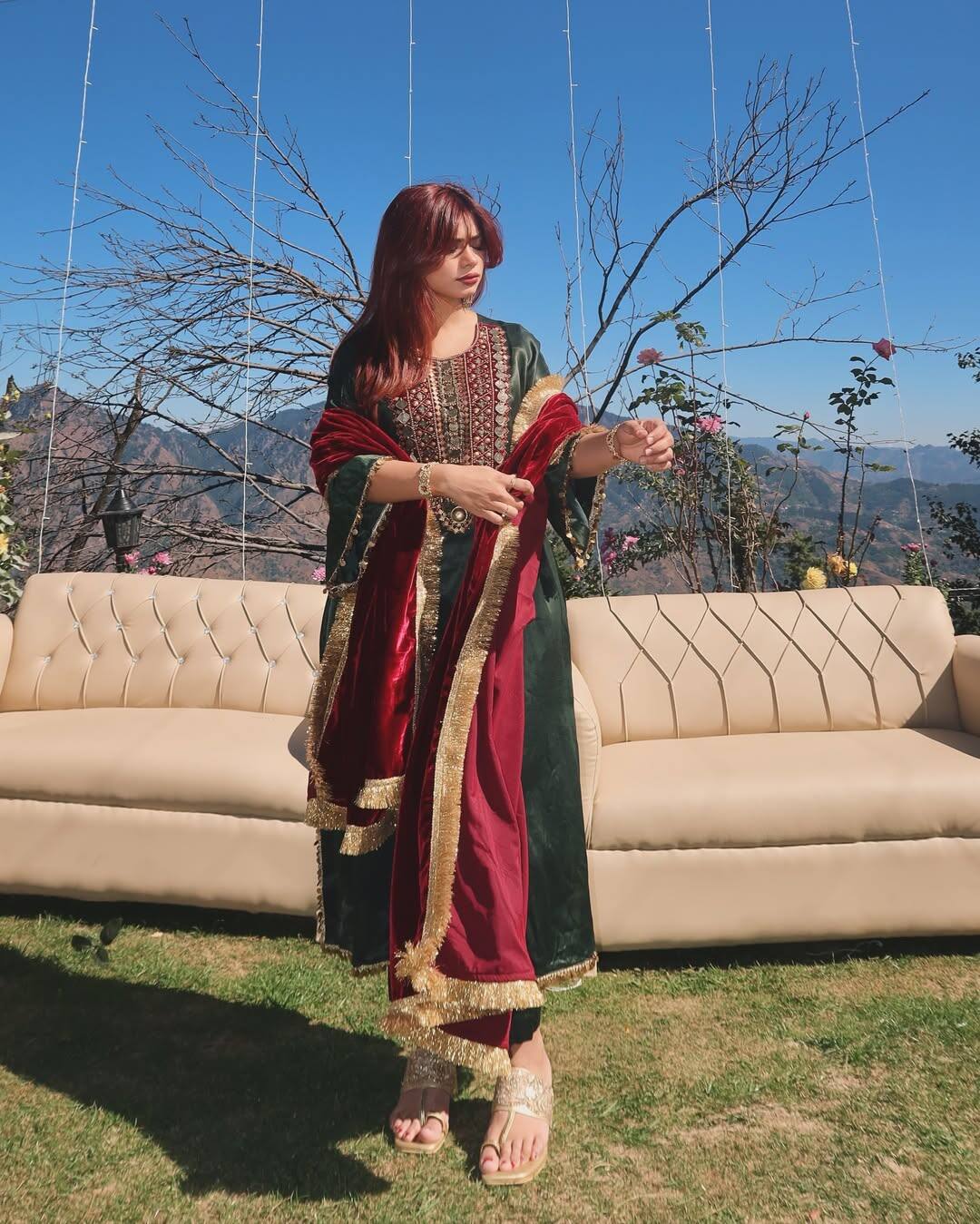 In this picture, Nagma is wearing a heavy work suit with magenta and green combination. Which she has paired with a golden border dark green dupatta. She is wearing golden heels, who is doing perfect matches with outfits. She has kept her open with soft curls. This look is quite royal and festivals.
