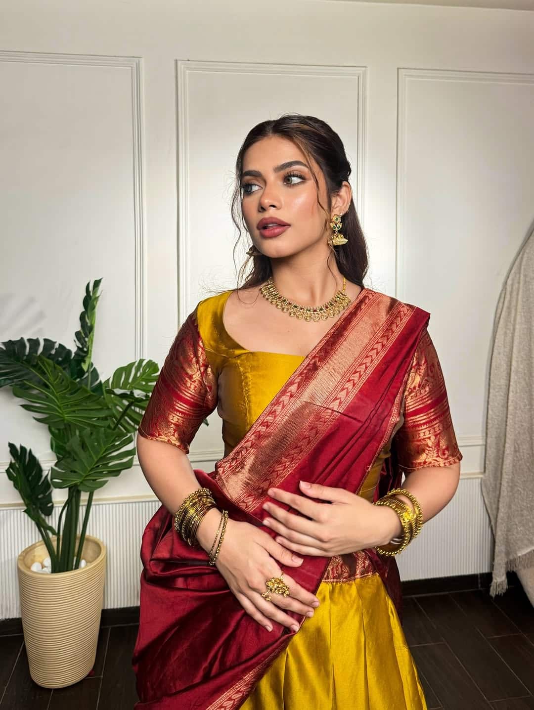 In this picture, Nagma is wearing Yellow and Marun silk saree. She has created a classic traditional look with gold jewelery, bangles and minimal makeup. They have kept the hair in low bun style, which is giving Royal Vibes with this saree.
