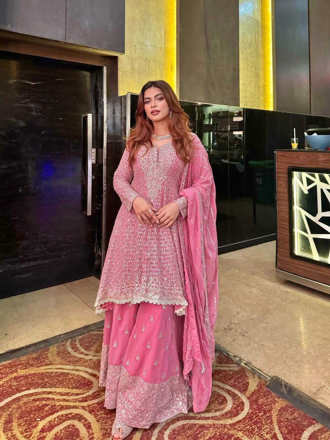 In this picture, Nagma has carried an embroidered suit of baby pink color. Sequin and thread work done on the suit is giving it a festive touch. They have pair it with matching dupatta and open curly hairstyle, giving them a simple and elegant look.