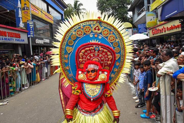 The streets come alive with Pulikali, the tiger dance, where performers painted as tigers and hunters captivate crowds with their energetic moves and pulsating rhythms. (Credit: PTI)