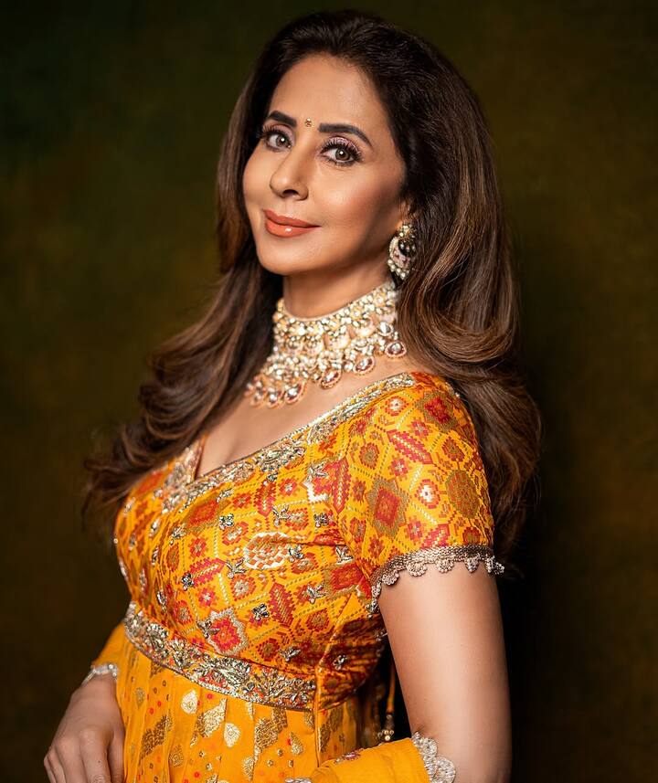 The upper part of Anarkali is decorated with multicolor ethnic print and gota-leaf work, which gives a beautiful touch of contrast in the look. It has been taken with a matching scarf, which has lace work on the edges, which is making the dress more graceful.