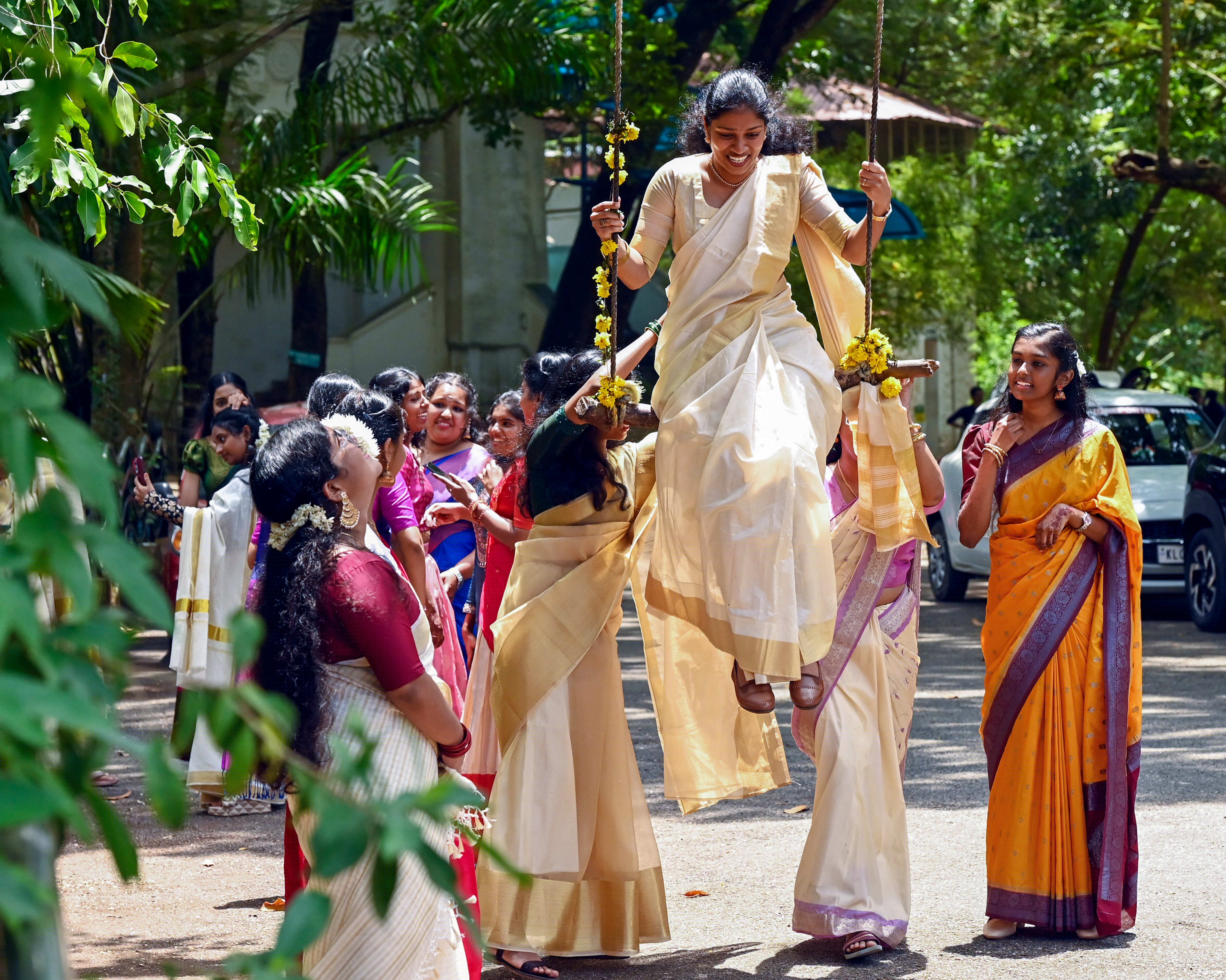 Traditional attire adds elegance to the celebration. Women don the graceful kasavu saree, woven in cream with golden borders, while men wear the dignified mundu, embracing Kerala’s timeless aesthetic. (Credit: PTI)