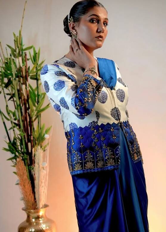Sapna looks quite attractive in jacket style blouse with blue saree. Looking at them, it can be said that she is the mallika of beauty.