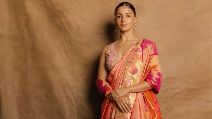 Custom Paithani Saree: She shines in this custom Paithani saree styled in Nauvari drape, paired with a baby pink embellished blouse. The deep V neckline and backless cut bring a contemporary twist to tradition. (Image Source: Instagram/ aliaabhatt)