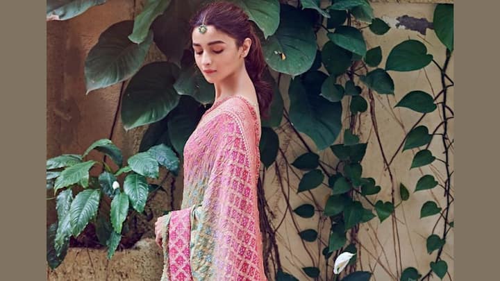 Banarasi Bandhej Saree: She looks graceful in this Banarasi Bandhej saree in ombre pink and green hues, enriched with zari motifs. A nude makeup look and maang tikka add to its festive charm. (Image Source: Instagram/ aliaabhatt)