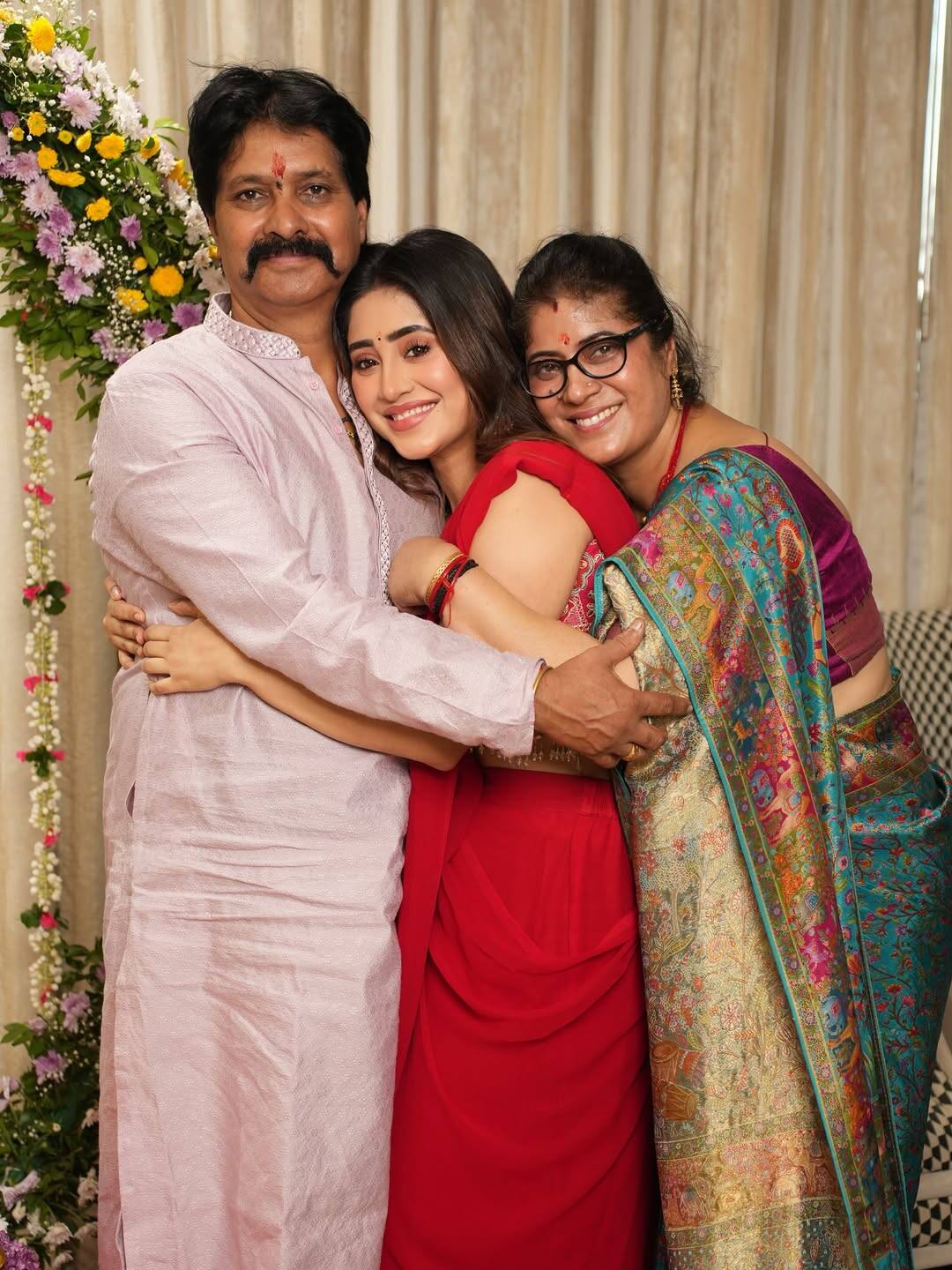 In this picture, Shivangi Joshi is seen showering his mother and father in love.