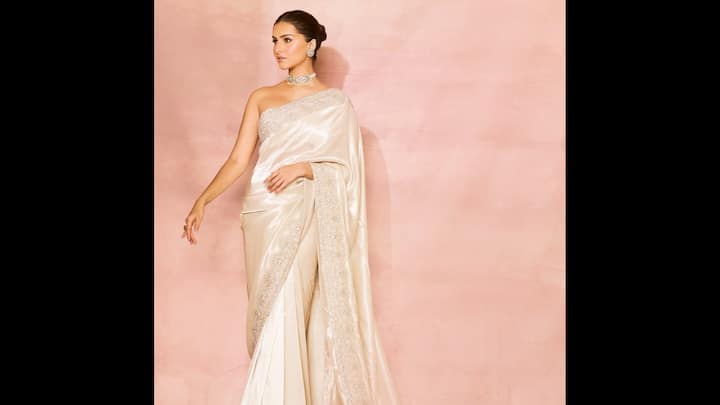 1. Tara Sutaria: Tara Sutaria: Tara Sutaria turned heads in this stunning ivory saree. Her contemporary ethnic fits proved that minimalism can be the most glamorous statement. The sari featured a delicate embroidered border, paired with a chic strapless blouse. The actress elevated her look with a sleek bun and pear jewellery. This look is a great inspiration if you want to wear a sari but keep it modern and elegant. (Image Source: Instagram/@tarasutaria)