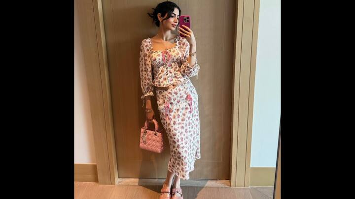 8. Khushi Kapoor: Khushi Kapoor has quickly become a fashion force, captivating a new generation with her effortlessly cool, Gen-Z style. This stunning floral co-ord set is a perfect example, proving that you can look both chic and carefree at the same time. It's the perfect look to copy for any casual outing. She channels pure vacation chic in this pastel floral co-ord set. The ensemble features a whimsical peasant-style top with a lace-up front and a flattering sweetheart neckline, perfectly paired with a matching midi-length skirt. This floral co-ord set is a dream for anyone who loves a fuss-free yet stylish outfit. (Image Source: Instagram/@khushikapoor)