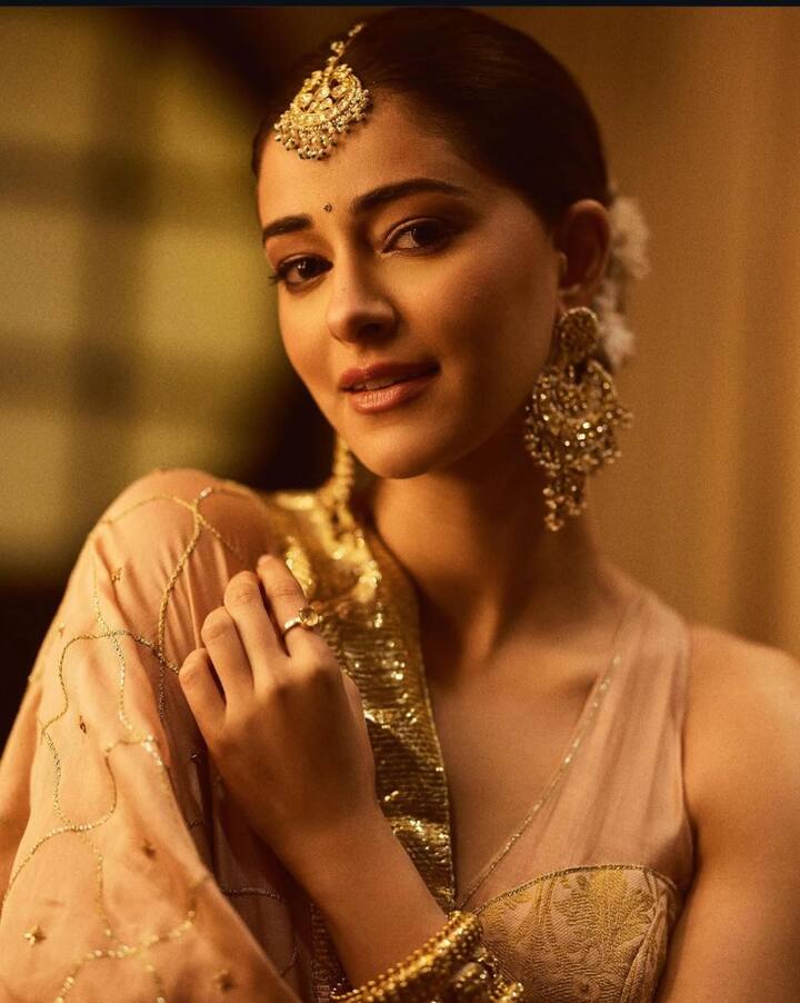 Ananya Panday: Vibrant and Regal - Ananya Panday radiates festive cheer in a bright purple lehenga adorned with golden embroidered detailing across the skirt and blouse edges. Keeping her look regal yet effortless, she pairs the outfit with golden jewelry, letting her ensemble exude pure festive vibes.