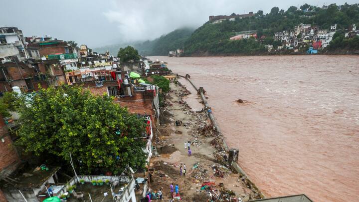 The Gujjar nagar area near the Tawi river which continues to flow in spate amid rainfall, in Jammu. (Image Source: PTI Images)