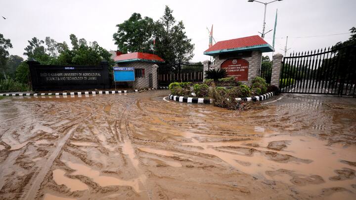Road filled with mud water outside the Sher-e-Kashmir University of Agricultural Sciences and Technology of Jammu (SKUAST-Jammu) following flash floods, at Chatha, on the outskirts of Jammu. (Image Source: PTI Images)