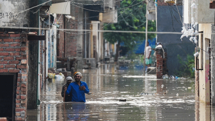 Heavy rain in Delhi has swelled the Yamuna, raising the water level above the danger mark and inundating homes and markets in low-lying area. The rising water level has forced families to evacuate.
