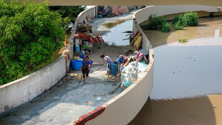 Families survived on biscuits and buns, told one resident to news agency PTI. Elderly parents were carried through waist-deep water, while children and pets huddled in roadside tents. Image: PTI