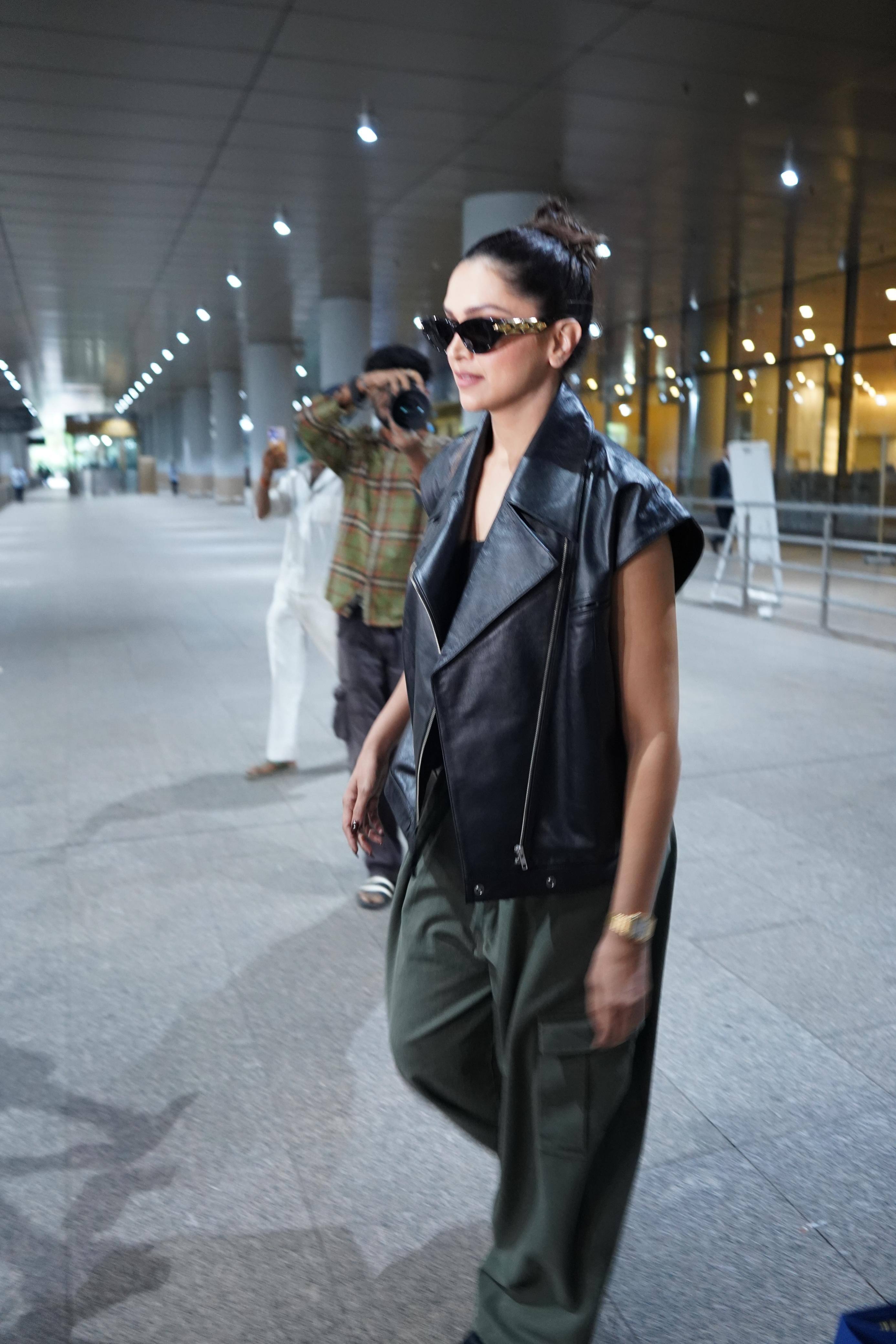 Deepika is wearing a black top inside a black leather sleeveless jacket that is giving her a stylish vibi.