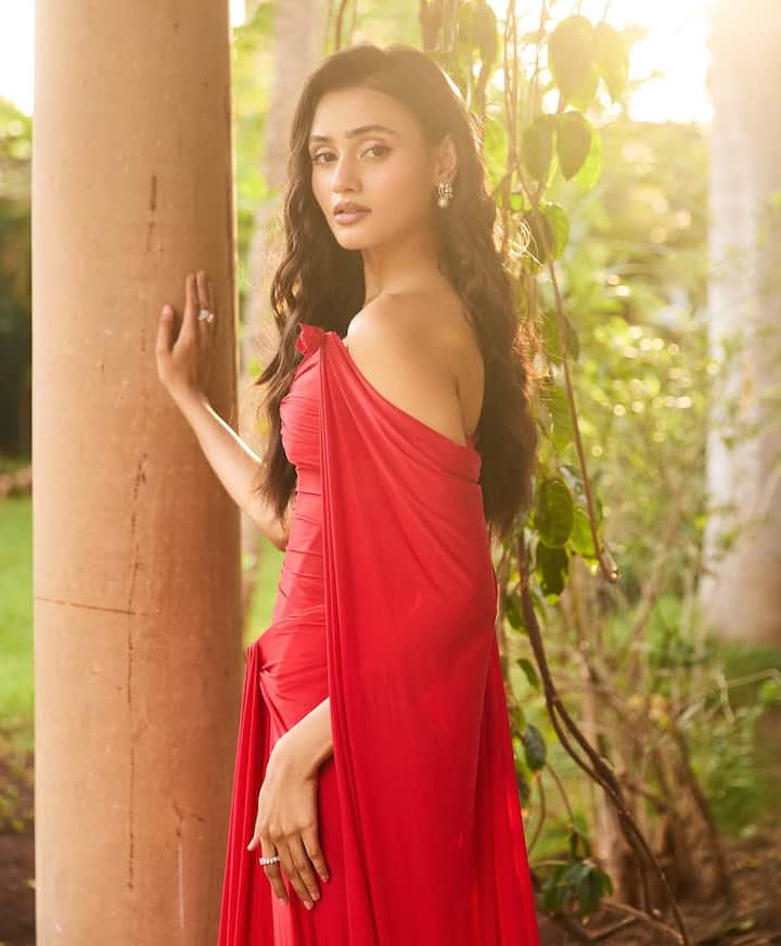 Janaki is very well covered in this red color dress, Janaki's look with backless dress and nude makeup is giving glamorous vibe.