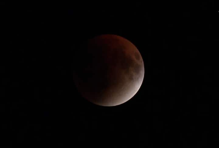 During totality, the moon moves into the Earth’s darkest shadow, the umbra. As sunlight passes through the atmosphere, blue wavelengths scatter while red light continues, casting a crimson hue on the lunar disc. This effect, known as Rayleigh scattering, is also responsible for the orange glow of sunsets and the blue of daytime skies. In this image is a red moon in New Delhi. (ANI Photo)