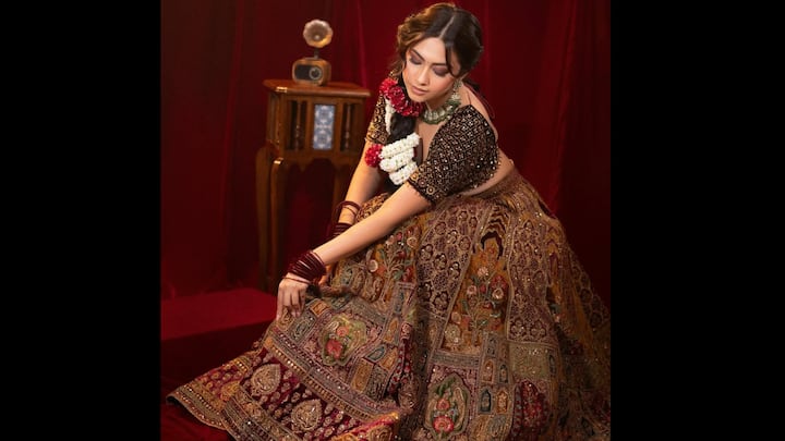 2. Heavily Embroidered Lehenga: Reem Shaikh channels pure regality in this intricately embroidered maroon lehenga. The heavy zari and threadwork detailing across the skirt exudes grandeur, while the contrast black blouse with delicate embellishments adds a contemporary balance to the ensemble. With its rich craftsmanship and opulent textures, Reem’s lehenga is the epitome of festive luxury fashion. (Image Source: Instagram/@reem_sameer8)