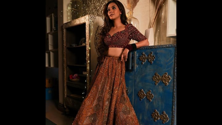 8. ⁠Radiant Festive Lehenga: This outfit is a perfect choice for any grand celebration, be it a wedding reception, a Diwali party, or a formal sangeet. The ensemble features a vibrant, deep-hued lehenga skirt adorned with intricate, all-over embellishments that catch the light with every movement. he look is completed with a heavily embroidered, plunging V-neck blouse that adds a touch of modern drama and sophistication. The detailed beadwork and sequin embroidery on the blouse are a testament to exquisite craftsmanship. (Image Source: Instagram/@reem_sameer8)