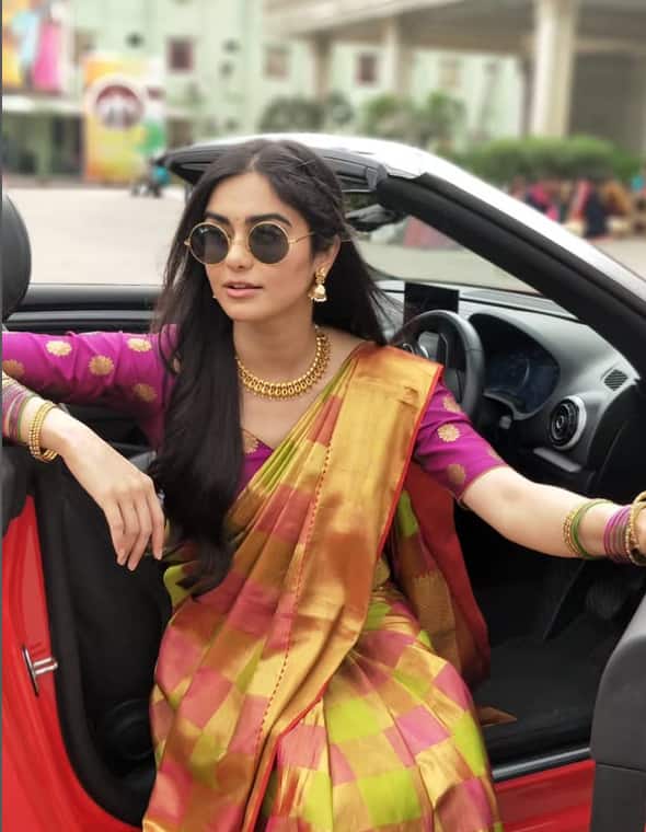 The actress is looking quite classy in this silk saree. His swag is reflected in gold jewelery and black glasses.
