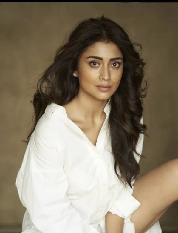 Only wearing a white color shirt, Shriya looks very stunning in this picture. She is left open by curling her hair and in a no makeup look, the actress looks amazing.