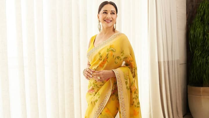 Day 4 – Yellow: Bright and refreshing, her yellow floral saree spreads cheer and positivity. The vibrant print with statement earrings makes this look festive-ready while staying chic. (Image Source: Instagram/ madhuridixitnene)