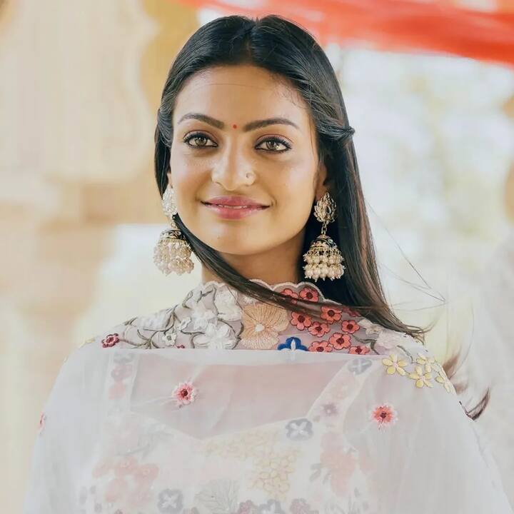 Monalisa looks like an angel in a white suit. Heavy earrings and red bindi on the forehead are adding charm to her look.