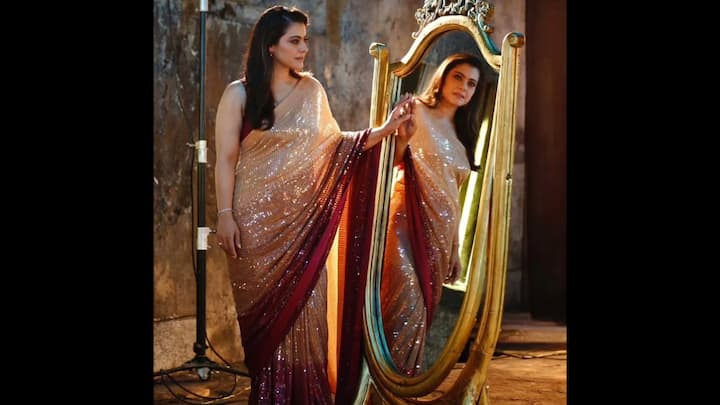 7. ⁠Dazzling Dual-Toned Saree: The saree itself is a study in refined artistry, featuring a subtle yet striking golden border that adds a touch of regal opulence. The beauty of this ensemble lies in its seamless blend of tradition and modernity. The lightweight, flowing fabrics allows the saree to drape effortlessly, creating a silhouette that is both graceful and comfortable. With minimal jewellery, consisting of delicate earrings, the ensemble radiates a serene and sophisticated charm. (Image Source: Instagram/@kajol)