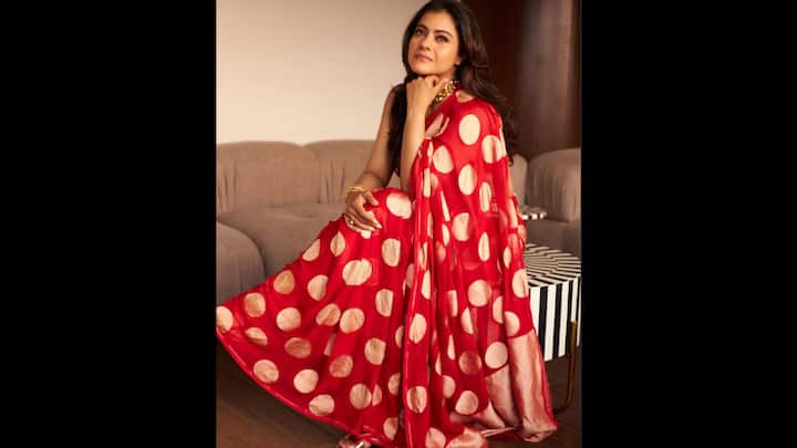 3. ⁠Red And Gold Polka Dot Saree: Kajol channels timeless retro vibes in this stunning red saree featuring oversized golden polka dots. The vibrant drape instantly stands out, bringing back the charm of vintage Bollywood with a festive twist. For Durga Puja 2025, this saree is an ideal pick. Paired with a sleeveless blouse, the look captures both playfulness and sophistication. Kajol styles it with statement jewellery and loose waves, proving that a classic print can be reimagined into a modern festive fashion statement. (Image Source: Instagram/@kajol)