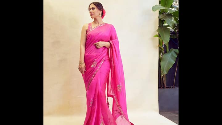 2. ⁠Bold Hot Pink Saree: Kajol makes a striking impression in this hot pink saree, radiating elegance and festive charm. The saree is adorned with delicate sequin embellishments along the border and scattered floral motifs across the drape. Styled with a sleeveless blouse featuring a beaded neckline, the outfit carries both modern sophistication and traditional appeal. Perfect for Durga Puja evenings in 2025, this saree is an excellent choice for cultural gatherings, aarti, or festive get-togethers. (Image Source: Instagram/@kajol)