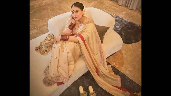 8. ⁠Regal Cream-Coloured Saree: This saree is the very definition of understated luxury. The main body of the saree is a serene beige. This muted base provides a perfect canvas for the saree’s broad, vibrant red border intricately detailed with golden motifs. Kajol elevates the simplicity of the saree with impeccable styling. She pairs it with a matching blouse. This is look a tribute to her Bengali roots. (Image Source: Instagram/@kajol)