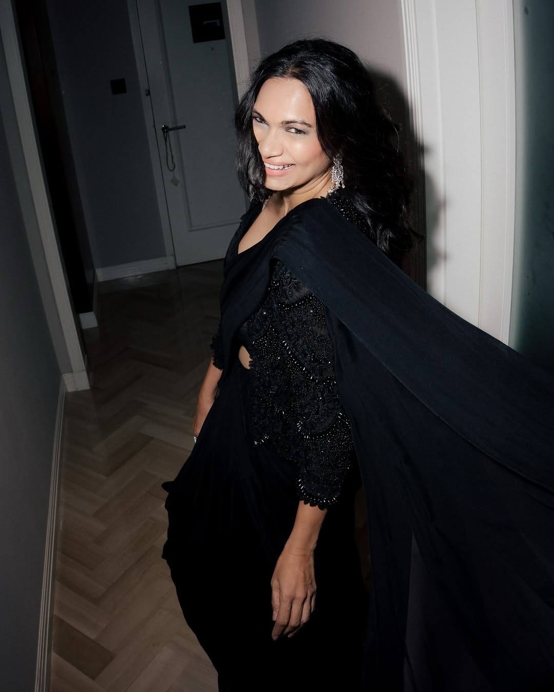 Maria is wearing a stylish gown of black color shimmer detailing in this look. Their open hair and earrings are making the look more graceful. His look is very classy.