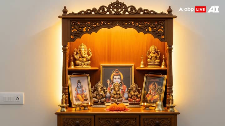 Choose the Right Pooja Unit or Mandir: The first thing to decide is a proper pooja unit or mandir. It can be a small wall-mounted wooden unit for compact spaces or a floor-standing one for bigger rooms. A wooden mandir often gives a warm and traditional look, while marble units feel clean and bright. Make sure the size of the unit matches the space available and has enough shelves for idols, photos, or other essentials. (Image Source: ABP LIVE AI)