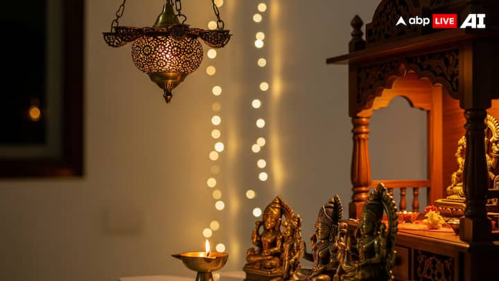 Lighting for Warmth: Good lighting makes the pooja corner look bright as well as quiet while being free from any kind of disturbance. A small lamp, a focus light, or even a string of fairy lights when decorated around the mandir looks very beautiful. Traditional brass hanging lamps can also be used here. Many people also keep a diya burning at specific times of the day, which itself spreads a warm yet positive glow. (Image Source: ABP LIVE AI)