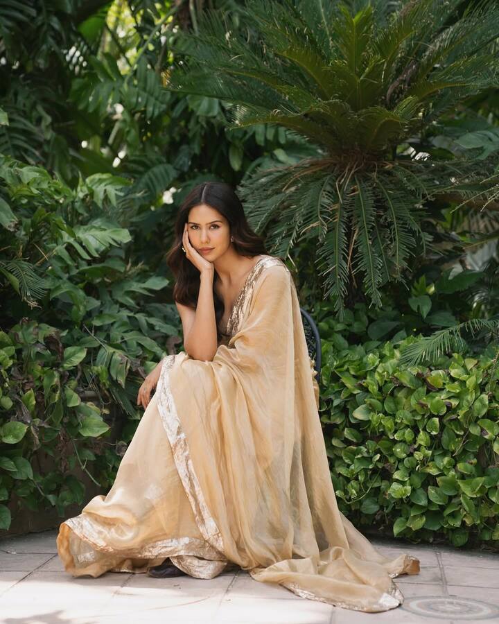 Sonam looks very royal and graceful in this look. She is wearing a light golden-bener saree with a golden border, giving the entire look aligant and rich touch. Open wavy hair and minimal makeup are further enhancing their natural beauty.