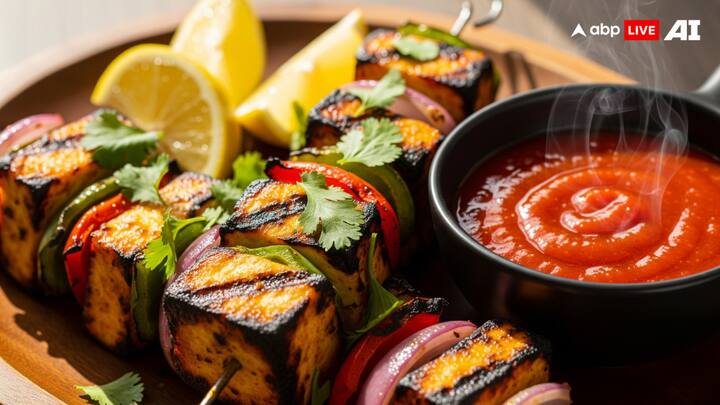 Bhoot Jolokia Sauce +  Paneer Tikka: With its spiced aroma and charred smokiness, paneer tikka is already a party favorite that enchants every gathering. However, it becomes a culinary firebrand meant for the daring when served with Bhoot Jolokia sauce. The smoky undertones on both terrains go so well together, and the paneer's creaminess balances the sauce's intense pungency. Spice lovers will love this combination, which combines comfort and a bold kick to create a stunning addition to any party platter. (Image Source: ABP LIVE AI)