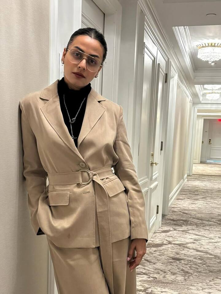 Namrata is known for her glamorous look. In this photo, Namrata has a black top carrying with a suit of beige color.