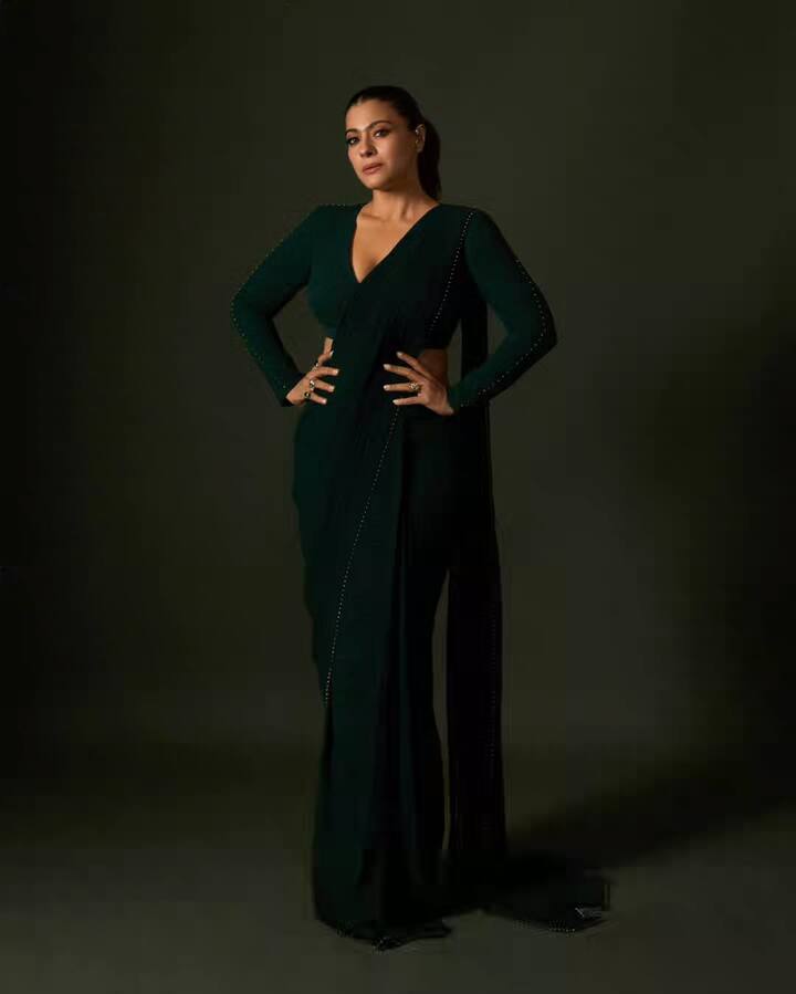 Here X Kajol is wearing a green saree, which looks very attractive. She is wearing this saree with a full-sleeve, deep-neck blouse. The sleeves of the blouse have a fine work of fine beads, which is putting four moons in their look. He has tied his hair in the back and wearing a ring. This entire look looks very modern and sophisticated.