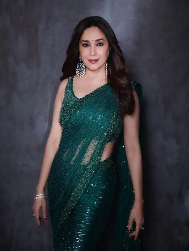 Like Madhuri Dixit, you can also style Shimri Green Sari. Like the actress, you complete your look with matching earrings.