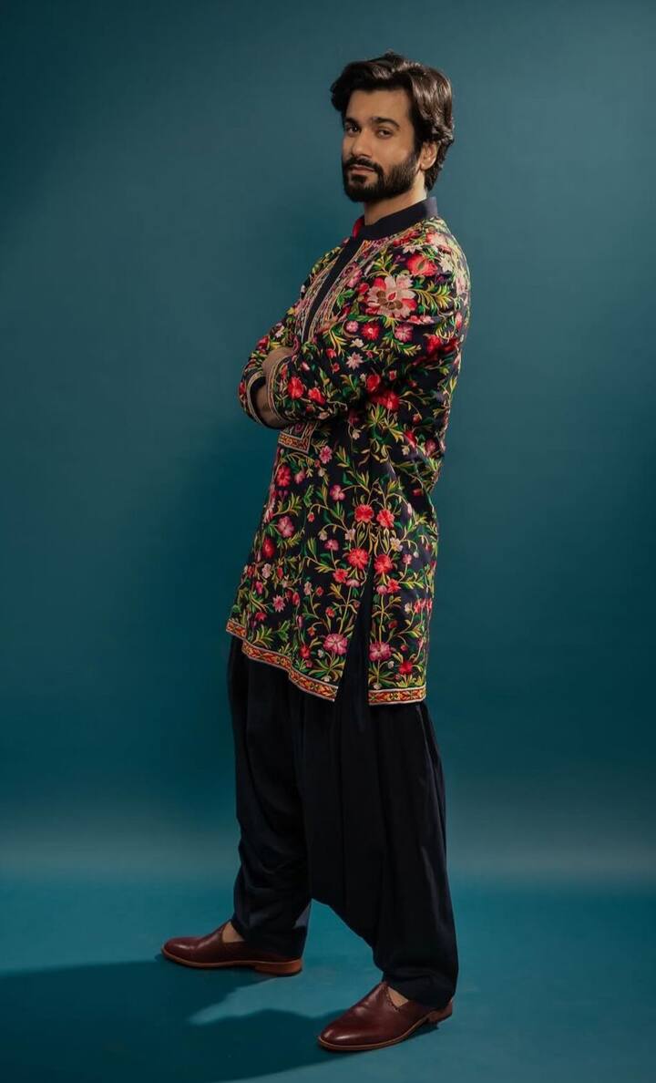 Floral Embroidery Done Right : Taking things up a notch, Sunny donned a black kurta covered in pink and green floral embroidery. He balanced the vibrant design with a classic black pathani and simple brown mojaris, letting the ornate kurta steal the spotlight. (All Image: Special Arrangement)
