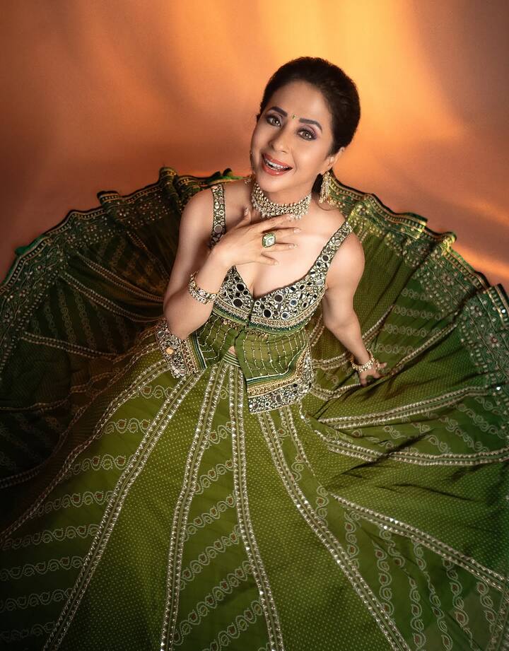 Urmila Matondkar pairs the lehenga with statement jewelry — a sparkling choker necklace, matching earrings, and coordinating bracelets. The accessories accentuate the regal vibe and harmonize with the lehenga’s detailing.