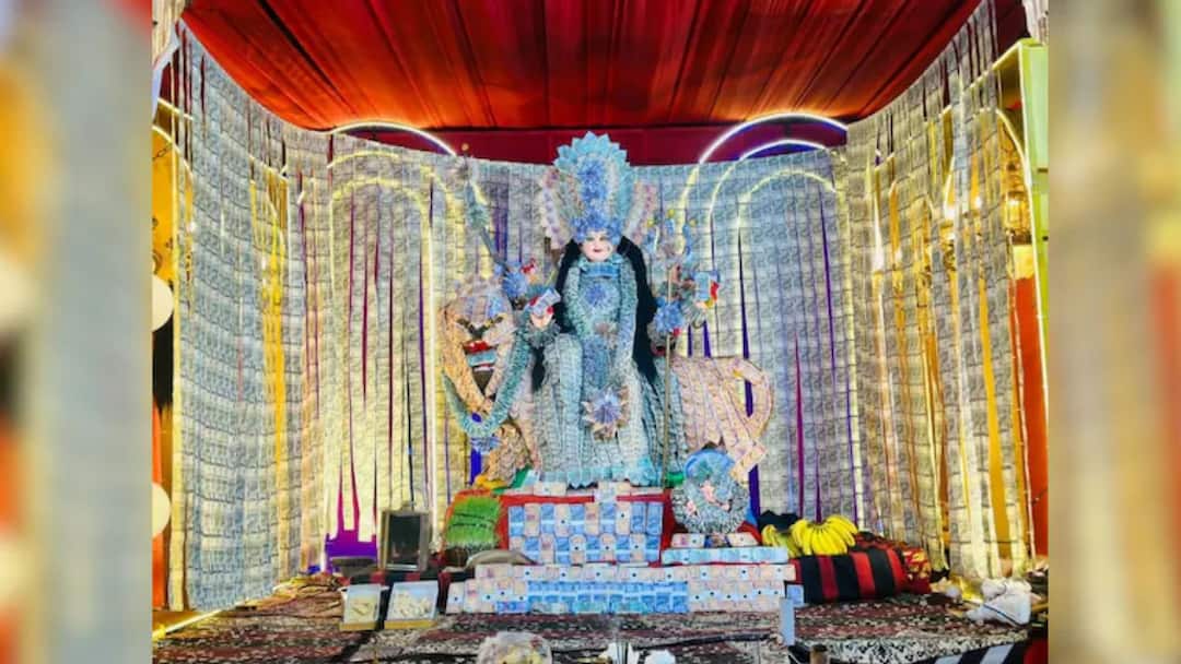 ৫১ লাখ টাকা দিয়ে তৈরি দেবীর মণ্ডপ! মুকুট থেকে মালা-টাকা দিয়েই মাতৃবন্দনা! Goddess Baleshwari Mata Adorned With Over Rs 51 Lakh In Cash ৫১ লাখ টাকা দিয়ে তৈরি দেবীর মণ্ডপ! মুকুট থেকে মালা-টাকা দিয়েই মাতৃবন্দনা!