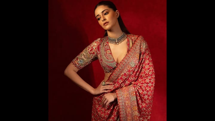1. Ananya Panday: Ananya Panday stuns in a breathtaking Tarun Tahiliani red saree, making it the ultimate festive pick for Karwa Chauth 2025. The intricately embroidered saree with floral and paisley motifs exudes timeless elegance, while the deep-neck blouse adds a bold, modern edge. Paired with a statement choker and sleek hair, her look beautifully balances tradition with contemporary glamour. If you’re searching for Karwa Chauth red saree inspiration, this look is a masterclass in blending heritage craftsmanship with Gen-Z chic. (Image Source: Instagram/@taruntahiliani)