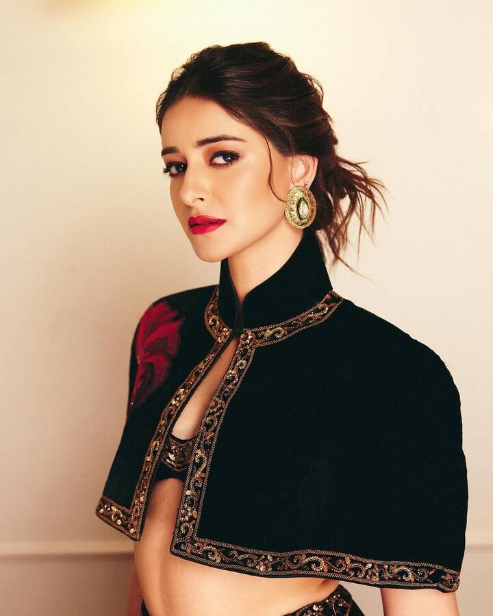 This hairstyle of Ananya Pandey is a trendy and gorgeous look for Karva Chauth. For this look, the hair is set upwards in loose and texcharged messi bun. There are some strands left on the forehead, giving the face a soft and romantic touch, as well as a light volume. This style beautifully shows their high-neck jackets and statement earrings.