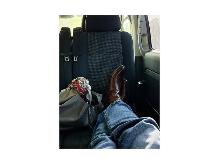 She showed off chic brown boots and a playful window-peek candid.