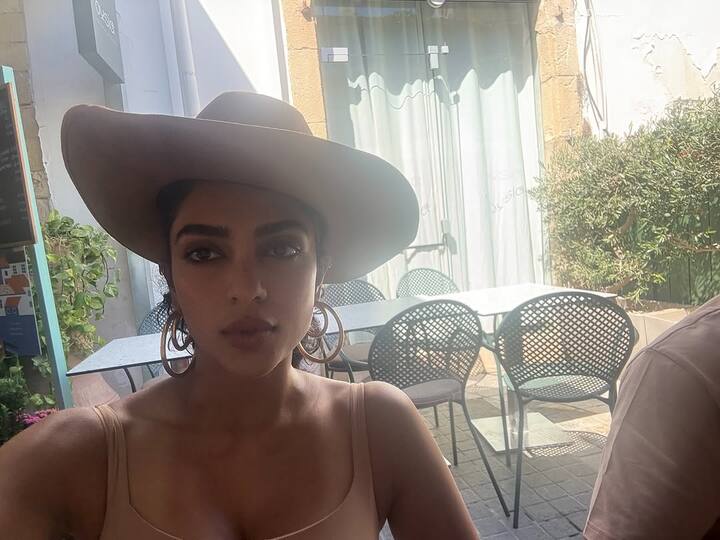 The first picture featured a golden-hour outdoor selfie in a tank top and hat.