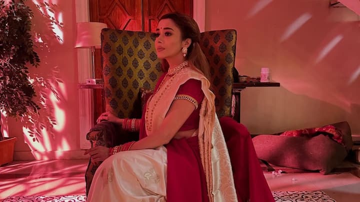 Tina Datta looks stunning in her latest photoshoot wearing a red and ivory saree paired with heritage jewelry. A perfect blend of timeless Indian elegance and cinematic nostalgia.