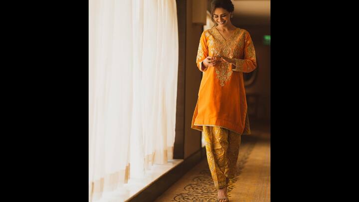 6. Radiant Mustard Ensemble: Mona Singh exudes warmth and festive charm in this stunning mustard-yellow outfit. The vibrant kurta, adorned with intricate gold embroidery, perfectly complements the traditional printed salwar, creating an elegant yet effortless festive look. The ensemble radiates joy and grace, making it ideal for daytime celebrations. With her hair tied back in a soft bun and minimal accessories, Mona proves that classic hues and clean silhouettes never go out of style. (Image Source: Instagram/@monajsingh)