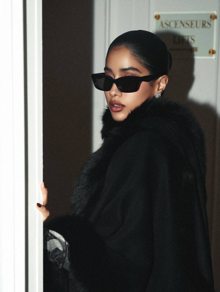 Janhvi tied her hair in a sleek, slicked-back braided bun, maintaining the retro aesthetic.