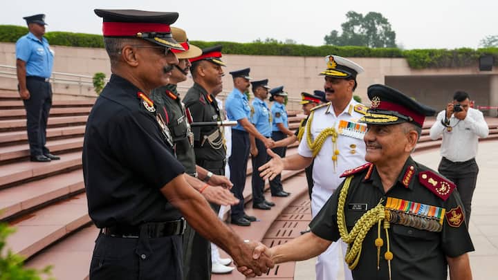 Chief of Defence Staff (CDS) General Anil Chauhan and Chief of the Naval Staff (CNS) Admiral Dinesh K. Tripathi interact with officials at the National War Memorial after paying tribute on the 93rd Indian Air Force Day. (Image Source: PTI Images)