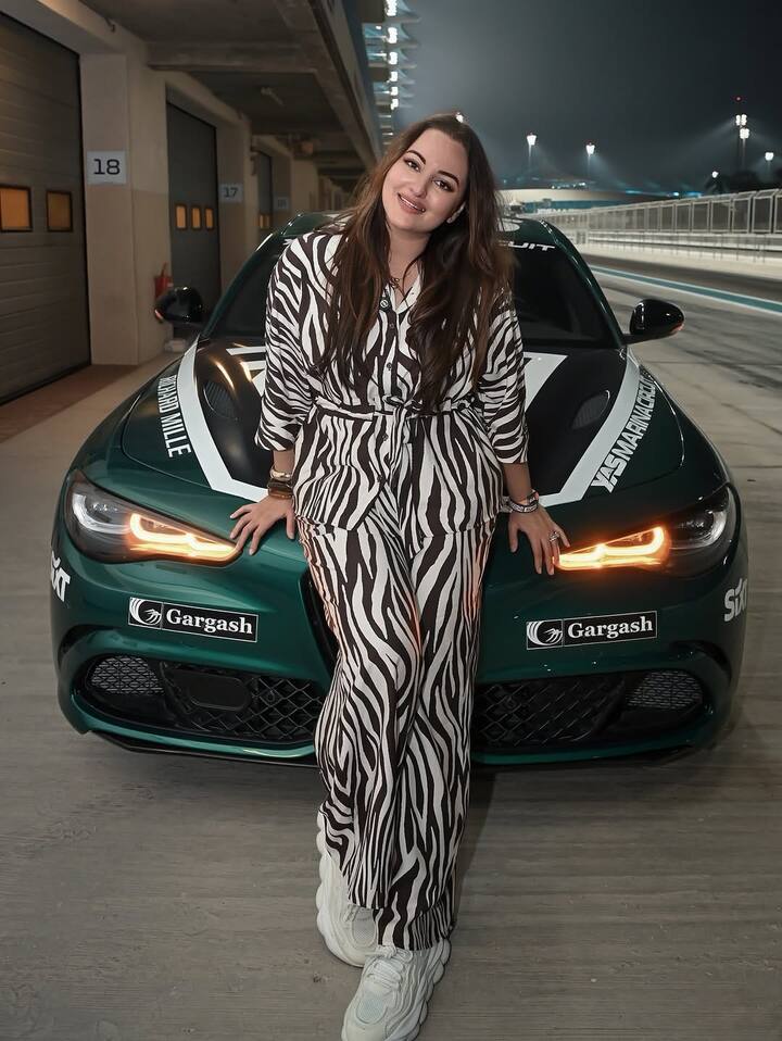 In this picture, the actress is seen posing in front of a sports car in a black and white striped outfit. Her casual look in white sneakers will definitely make anyone fall in love with her.